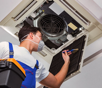 Close-up of technician cleaning AC filters during routine maintenance service